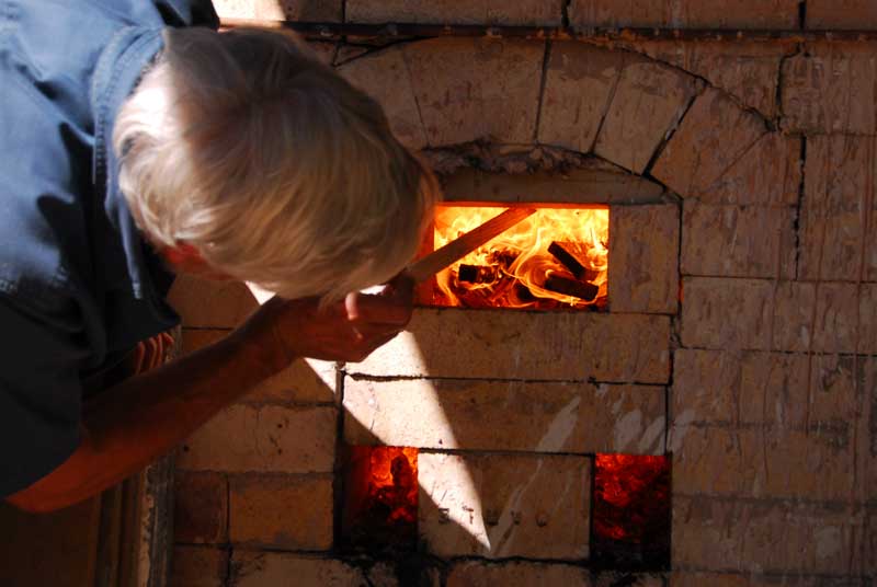 Stoking the kiln fire