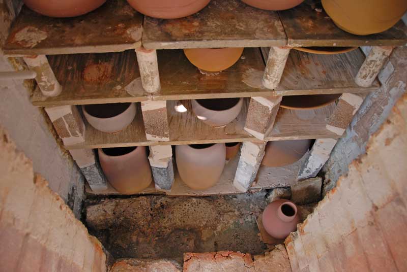 Salt kiln packed showing pot in the firebox